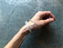 Load image into Gallery viewer, Silver Bangles | December 2 + 9&lt;br&gt;In addition to soldering, students will learn a variety of techniques to change the surface, color, and texture of their bangles...
